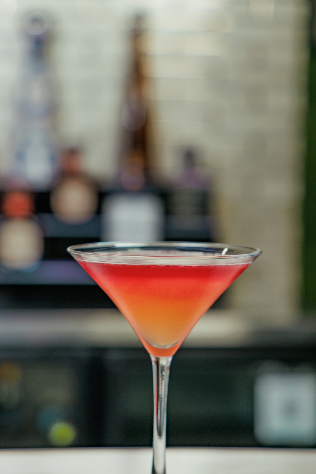 Sunset-colored martini at the bar