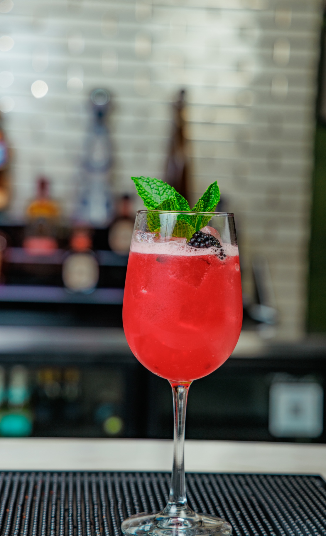 Berry sangria cocktail with mint and blackberry garnish