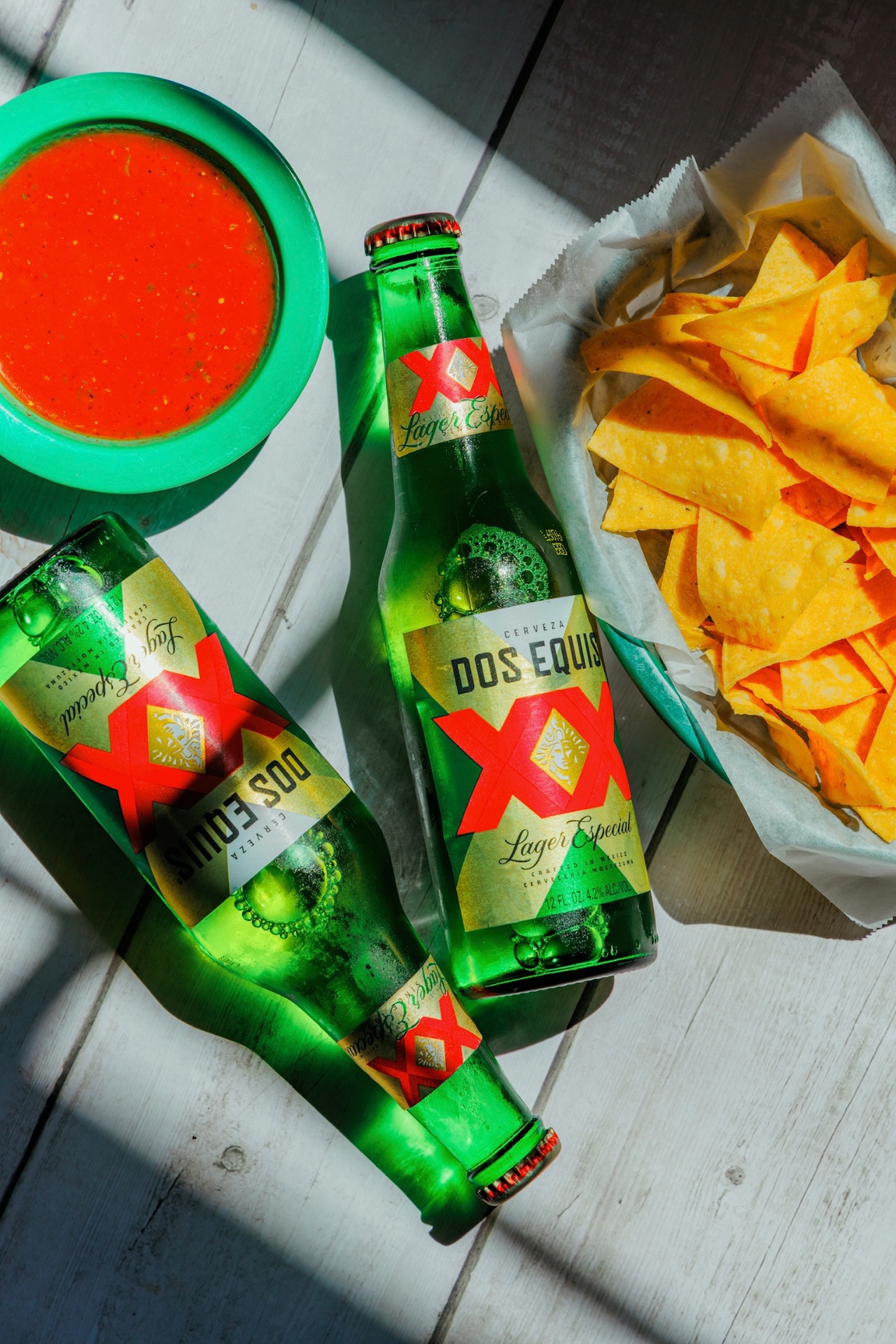 Dos Equis bottles with fresh salsa and tortilla chips