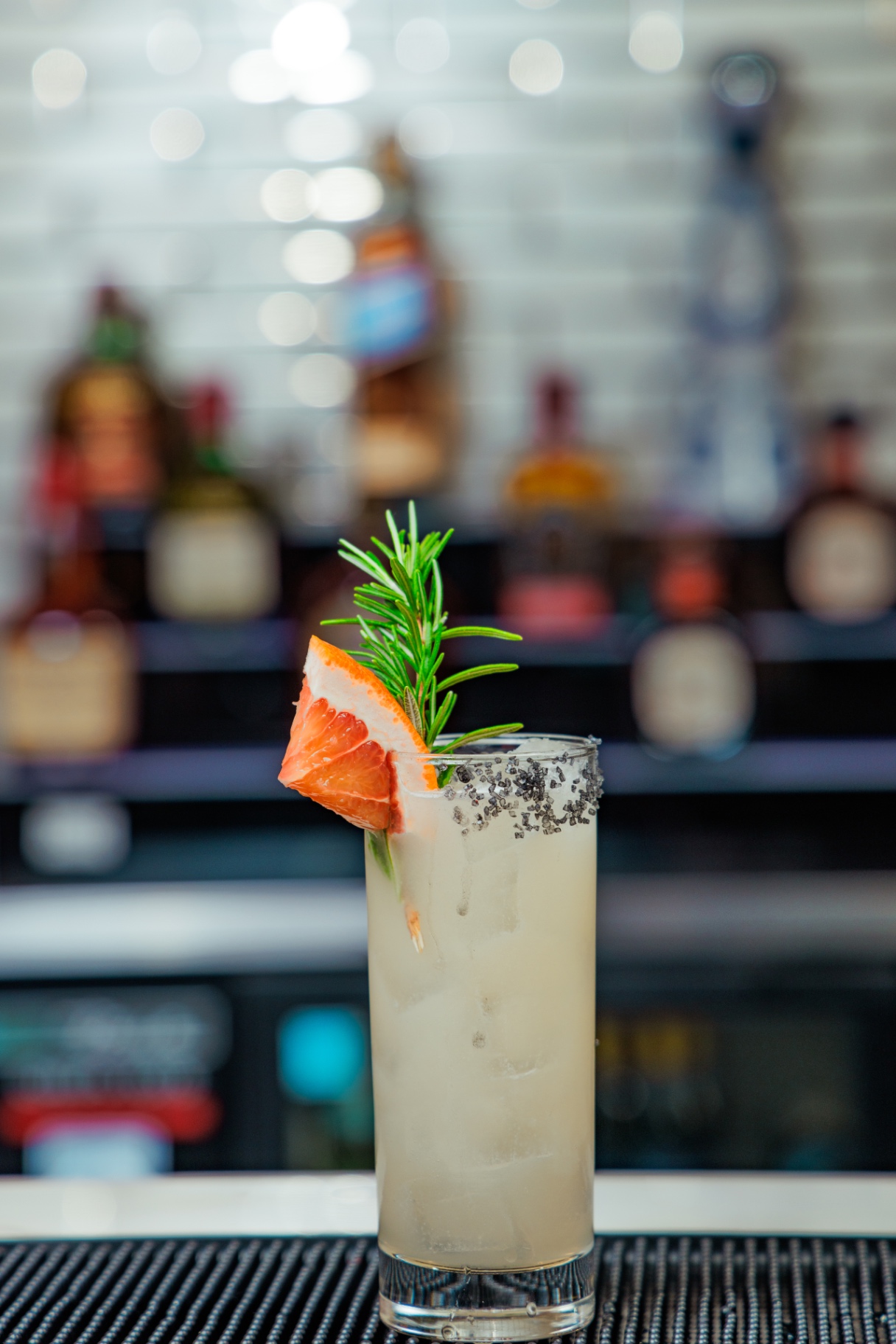 Grapefruit paloma with rosemary and black salt rim