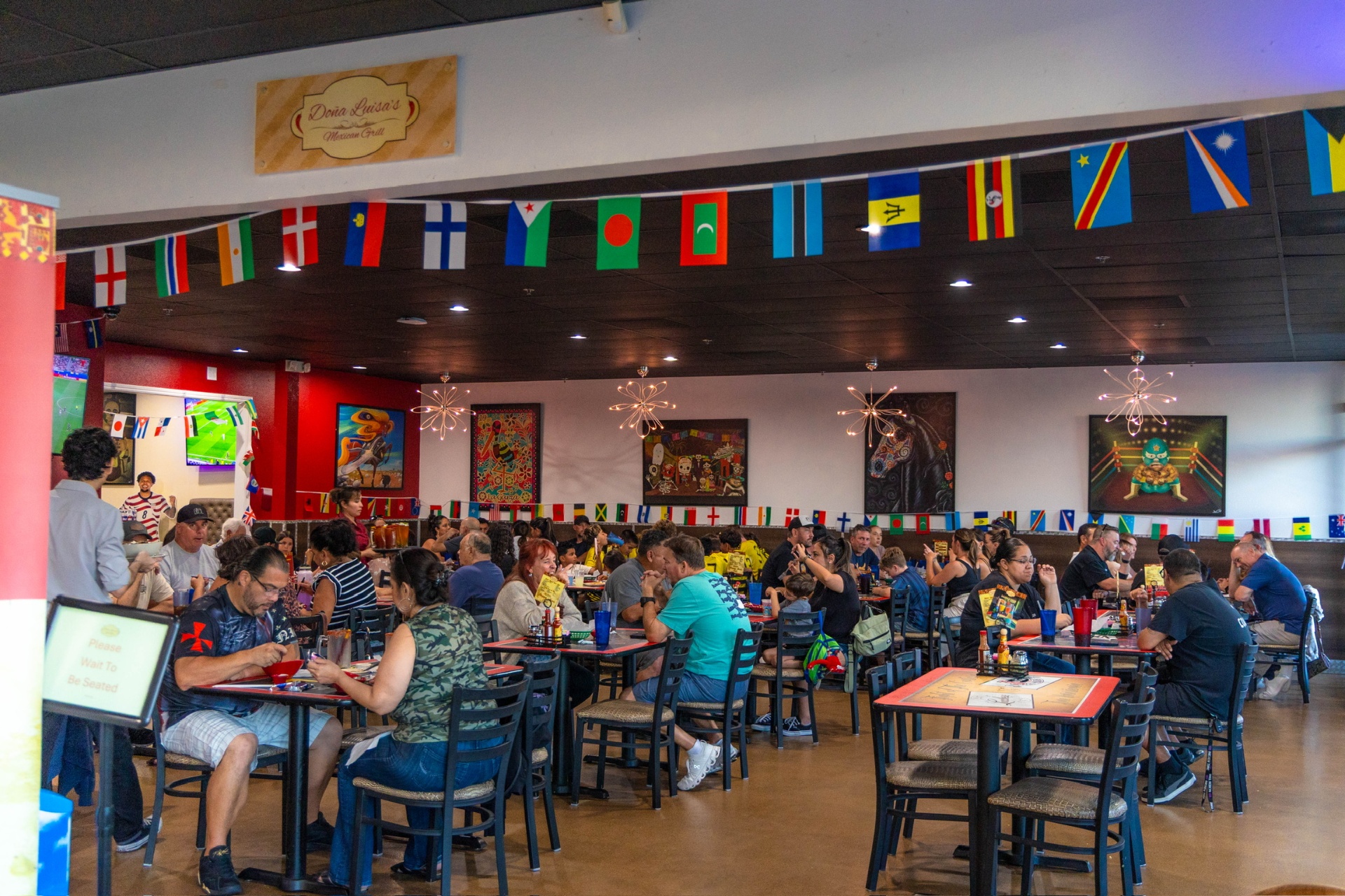 Doña Luisa's dining room with international flags and colorful murals